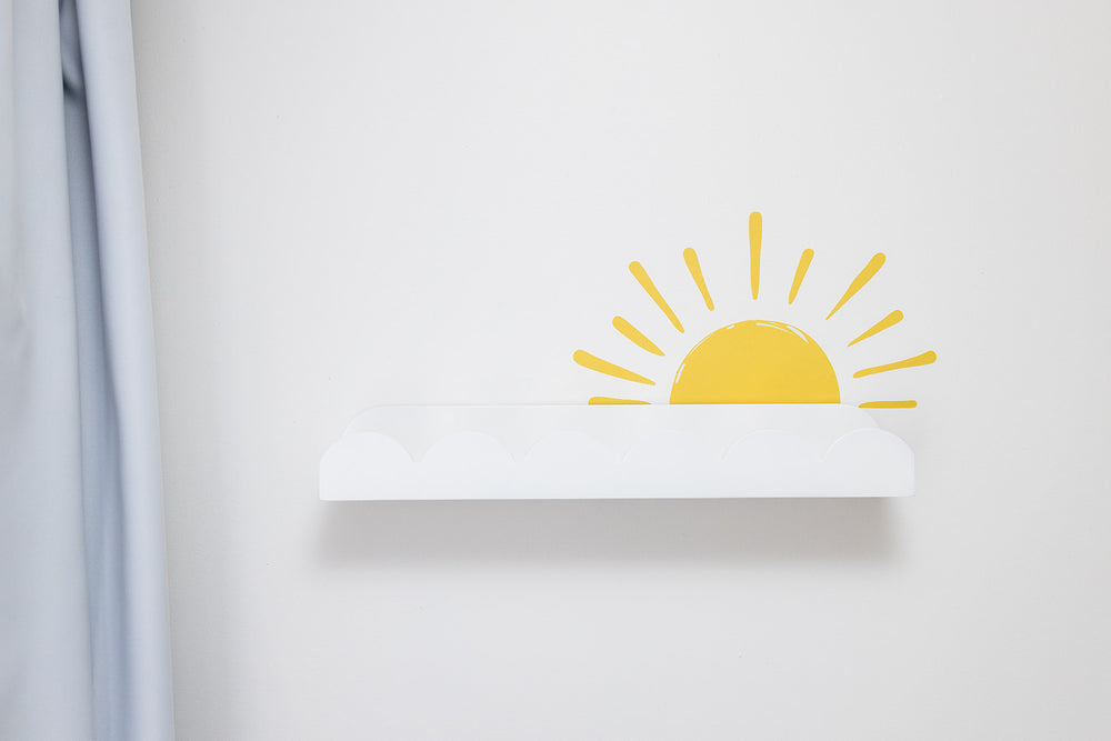 White wall with a yellow sun reusable decal sticker design on a light gray wall