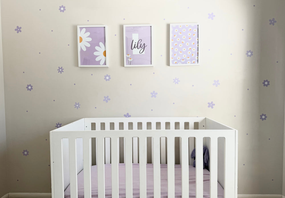 Lilac Daisy & Dots reusable wall decal stickers on a white wall with a white cot