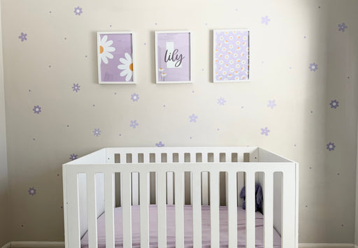 Lilac Daisy & Dots reusable wall decal stickers on a white wall with a white cot